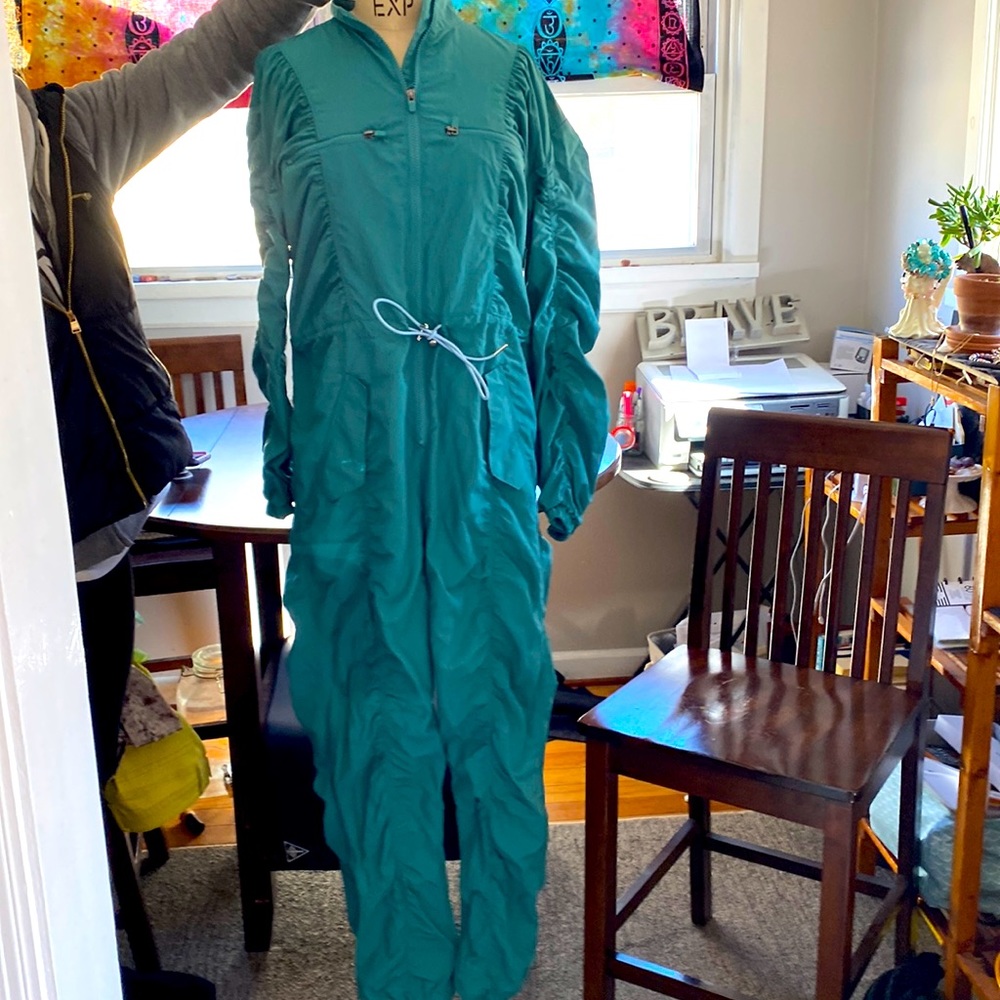 Fabletics one piece jumpsuit. Scrunchy arms, legs. Pockets at top and hips.